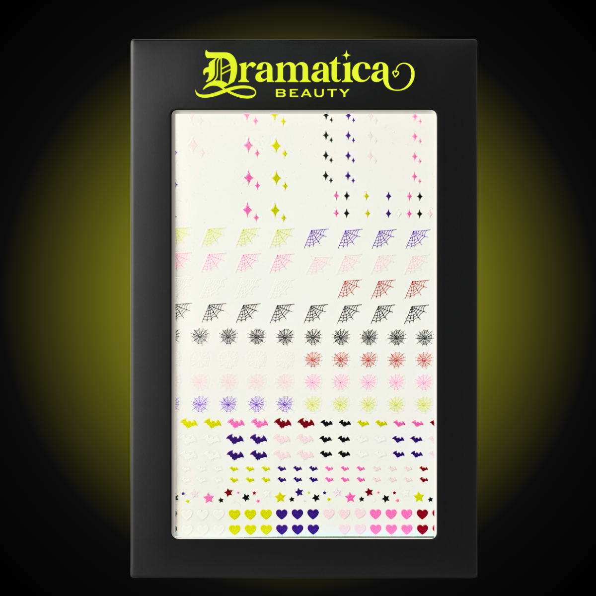 Dramatica Beauty's Nail sticker sheet. Featuring pink, green, purple, red, white and black original illustrations. These include spiderwebs, starbursts, bats, hearts, and stars.