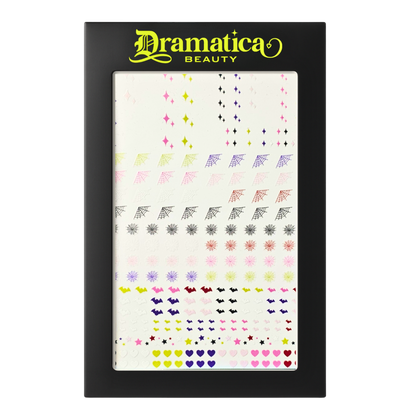 Dramatica Beauty's Nail sticker sheet. Featuring pink, green, purple, red, white and black original illustrations. These include spiderwebs, starbursts, bats, hearts, and stars. 